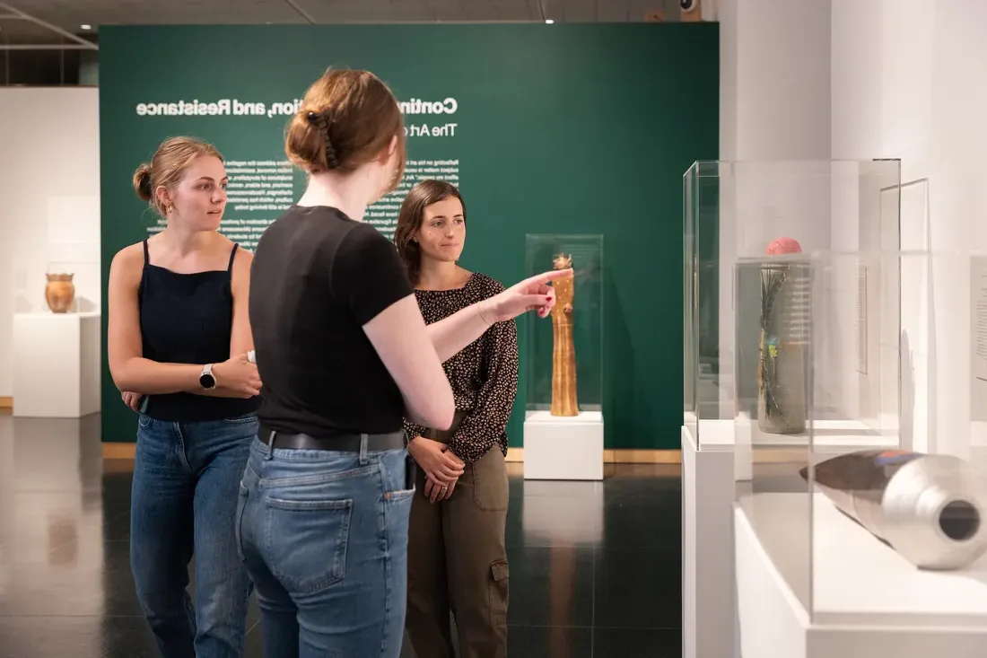 Students looking at art on display at art museum.